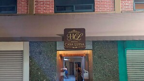 A hotel entrance with a sign reading 'Hotel Casa Luisa.'