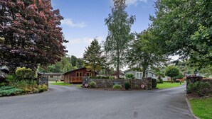 A residential area with a paved road, stone walls, and houses with visible front doors and windows. - 3 Bed in Stepaside (oc-fb132) (Stepaside)
