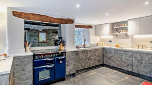 A modern kitchen with a built-in stove, marble countertops, and a stone backsplash. - 5 Bed in Cartmel (oc-80332) (Cartmel)