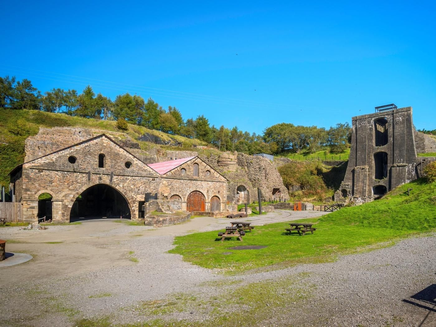 An old stone building with arched doorways and a bell tower.
