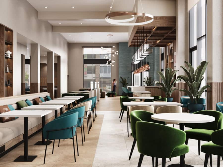 A modern restaurant interior with high ceilings, wooden paneling, and a mix of seating options including tables and booths.