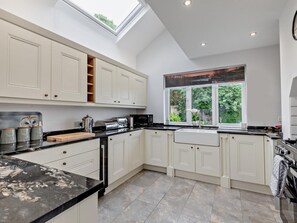 A modern kitchen with white cabinets, a black countertop, and a skylight. - 2 Bed in Ambleside (oc-82290) (Claife)