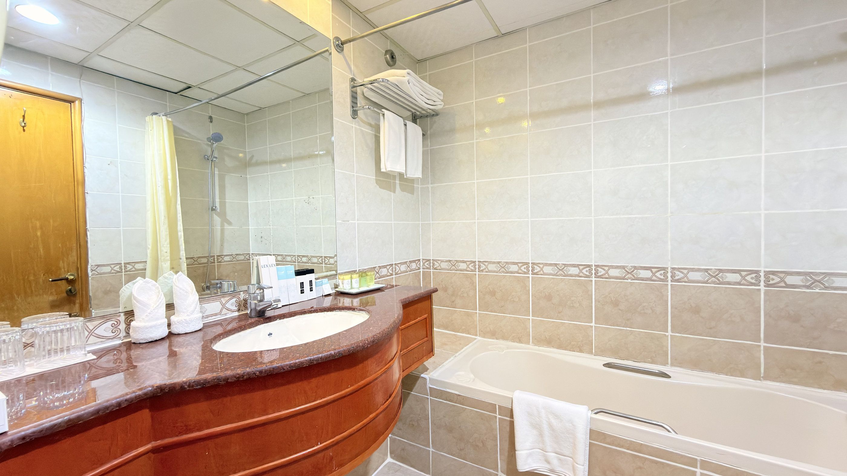 A bathroom with a marble sink, a bathtub, and a shower.
