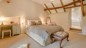 A bedroom with a bed, a desk, a chair, a window, and a ceiling with exposed beams. - 4 Bed in Tiverton (oc-82433) (Witheridge)