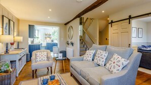A living room with a sofa, coffee table, and a dining area with a table and chairs. - 2 Bed in Grange-over-sands (oc-82672) (Cartmel)