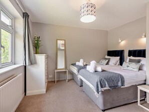 A bedroom with a bed, bedside tables, a dresser, a mirror, and a window with curtains. - 5 Bed in Wareham (oc-83036) (West Lulworth)