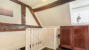 A room with a wooden ceiling, a white railing, a wooden cabinet, and a radiator. - 1 Bed in Kidderminster (oc-82957) (Cleobury Mortimer)