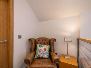 A corner room with a brown leather armchair, a small wooden side table, and a lamp. - 2 Bed in Lockerbie (oc-83269) (Lockerbie)