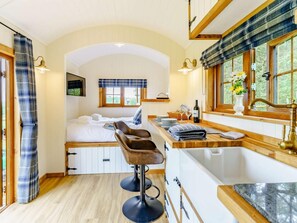 A cozy room with a bed, a bar area, and a sink. - 1 Bed in Pembroke (oc-83421) (Lamphey)
