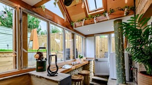 A kitchen with large windows, wooden beams, a bar area, and a potted plant. - 2 Bed in Morpeth (oc-83597) (Rothbury)