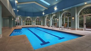 An indoor swimming pool with clear lane markings, surrounded by arched windows and lounge chairs. - Family-friendly, 2-bedroom condo with lots of amenities right on the beach. (Myrtle Beach)