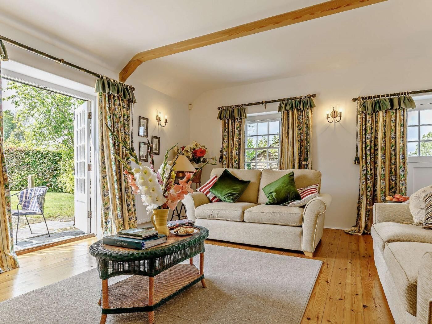 A cozy living room with a sofa, a coffee table, and curtains.