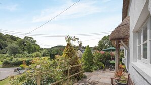 A residential property with a stone staircase leading to a porch, surrounded by lush greenery and a clear view of the countryside. - 2 Bed in Bideford (oc-83808) (Weare Giffard)