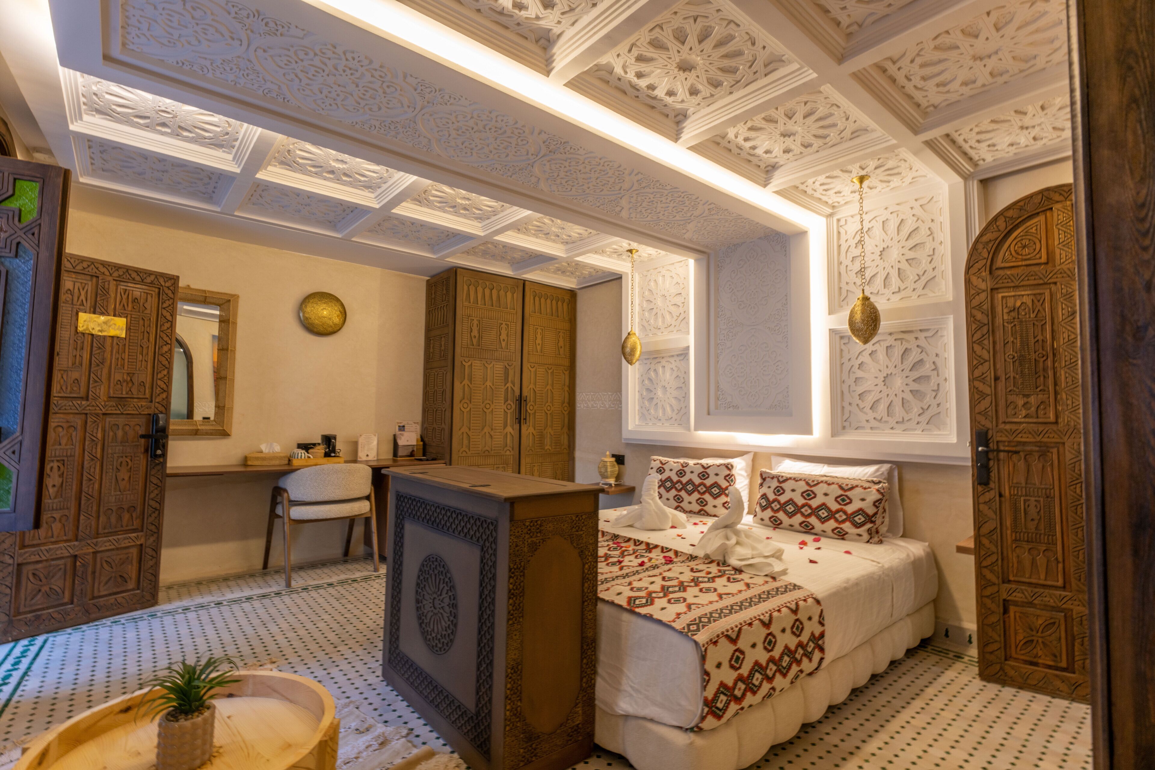 A traditional room with a bed, a desk, and a chair.