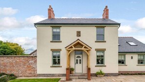 A two-story house with a front porch, brick chimney, and a well-maintained lawn. - 3 Bed in Poulton-le-fylde (oc-83787) (Hambleton)