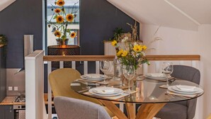 A dining area with a glass table, chairs, and a view of the outdoors. - 2 Bed in Cardigan (oc-83919) (Cilgerran)