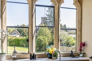 A window with a view of a house and trees. - 4 Bed in Bridport (oc-58847) (Powerstock)
