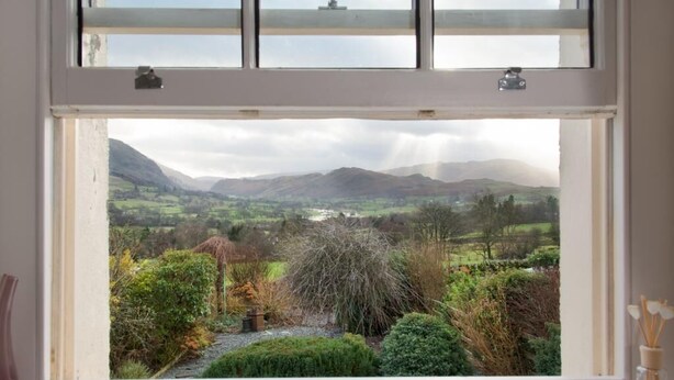 A window with a view of a rural landscape, including fields and mountains. - 2 Bed in Keswick (oc-sz082) (Threlkeld)