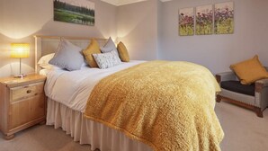 A bedroom with a bed, nightstand, lamp, and a chair. - 2 Bed in Keswick (oc-sz068) (Borrowdale)