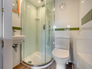 A modern bathroom with a glass-enclosed shower, a white toilet, and a sink with a chrome faucet. - 1 Bed in Keswick (oc-sz472) (Keswick)