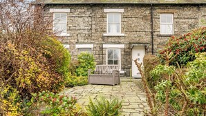 A stone house with a garden pathway leading to the entrance. - 2 Bed in Keswick (oc-sz036) (Keswick)