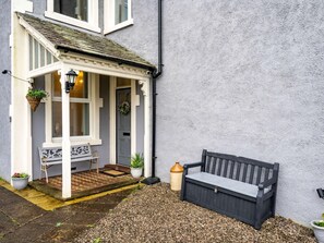 A house with a porch, a bench, and a potted plant. - 2 Bed in Holmrook (oc-sz464) (Irton with Santon)