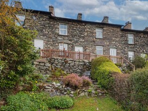 A stone building with multiple windows and a wooden fence. - 3 Bed in Penrith (oc-sz184) (Glenridding)