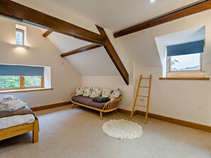 A bedroom with a loft bed, a sofa, a ladder, and two windows. - 4 Bed in Holmrook (oc-sz293) (Irton with Santon)