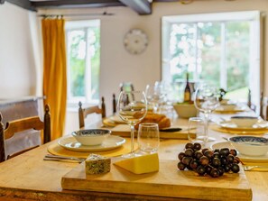 A dining table set with plates, glasses, a cheese block, and grapes. - 5 Bed in Ulverston (oc-sz587) (Broughton Beck)