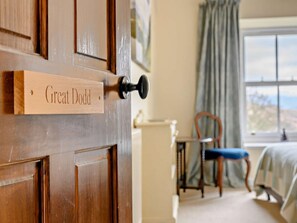 A wooden door with a nameplate reading 'Great Jodd' and a view of a room with a chair and a bed. - 4 Bed in Penrith (oc-sz367) (Dockray)