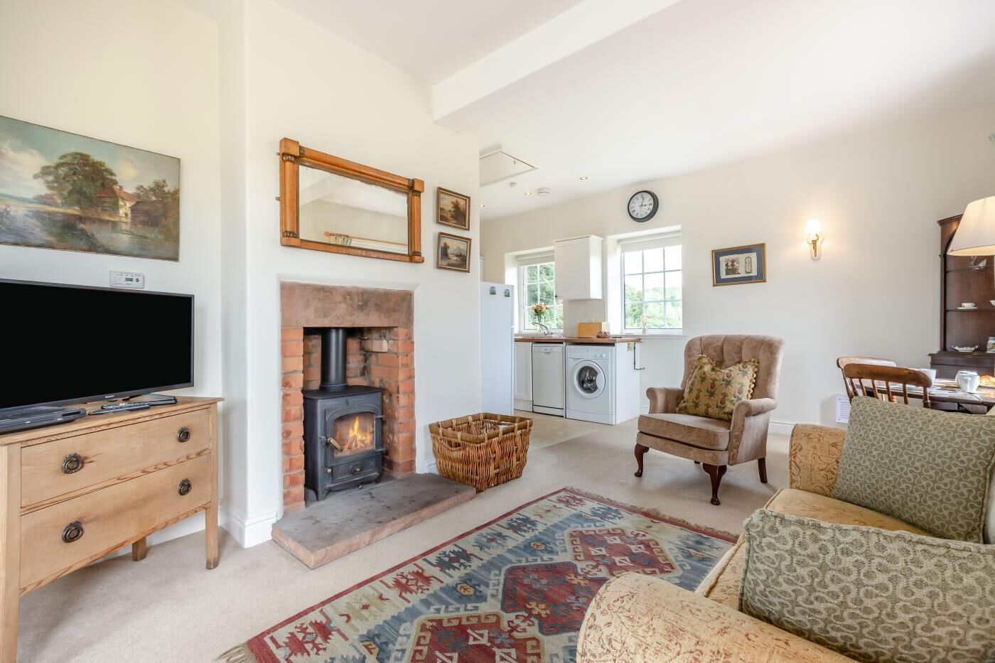 A living room with a fireplace, television, and seating area.