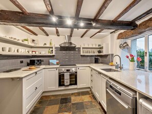 A modern kitchen with white cabinetry, a built-in oven, and a dishwasher. - 2 Bed in Ambleside (oc-84633) (Skelwith)