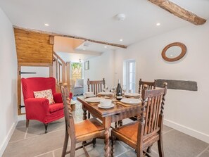 A dining area with a wooden table set for four, surrounded by wooden chairs. - 2 Bed in Kendal (oc-sz590) (Staveley)