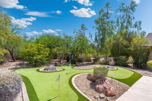 A miniature golf course with multiple holes, surrounded by landscaped areas and trees. - Scottsdale-Heated Pool-Spa-Pool Table-PickleBall (Scottsdale)