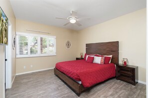 A bedroom with a bed, a nightstand, a ceiling fan, and a window with blinds. - Scottsdale-Heated Pool-Spa-Pool Table-PickleBall (Scottsdale)