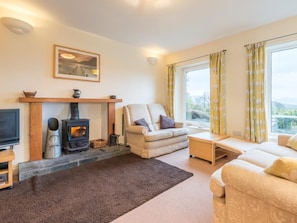 A living room with a fireplace, sofa, and a television. - 3 Bed in Keswick (oc-sz328) (Applethwaite)