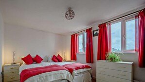 A bedroom with a bed, nightstands, a dresser, and a window with curtains. - 1 Bed in Penrith (oc-sz254) (Hutton)