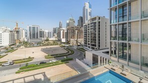 A modern high-rise building with a rooftop pool and a view of the cityscape. - Silkhaus Hyde Walk (Dubai)