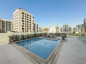 A rooftop pool with a clear view of surrounding high-rise buildings and construction cranes. - Silkhaus Hyde Walk (Dubai)