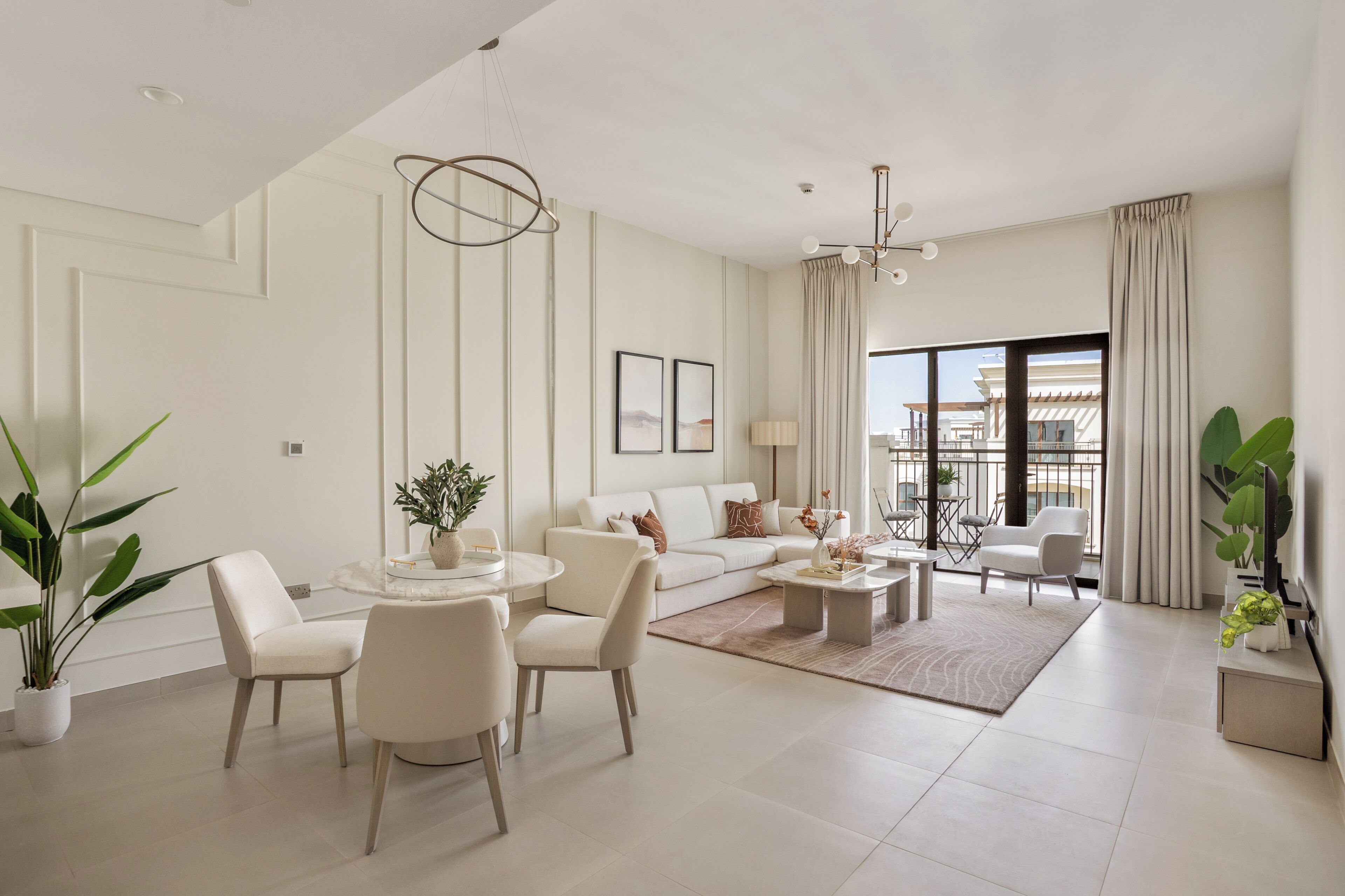 A modern living room with a sofa, chairs, a coffee table, and a dining table.