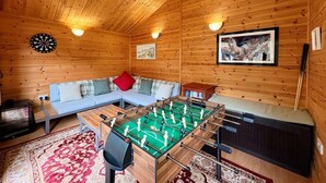 A cozy room with a foosball table, a sofa, a dartboard, and a bookshelf. - 1 Bed in Sandown (oc-85248) (Sandown)