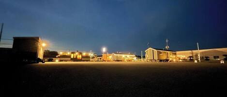 A large industrial building with multiple structures, including a warehouse and a smaller building with a sloped roof.
