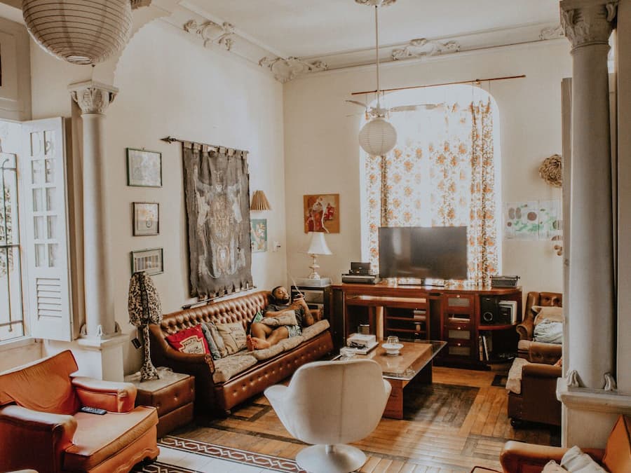 A living room with a sofa, armchairs, a coffee table, a television, and decorative items.
