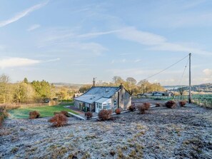 A rural house with a sloped roof, a fenced yard, and a view of the countryside. - 1 Bed in Lockerbie (oc-86068) (Lockerbie)