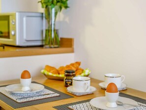 A breakfast setup with eggs, croissants, and coffee cups on a table. - 2 Bed in Cockermouth (oc-85514) (Cockermouth)