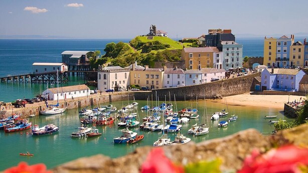 A coastal town with a historic fort, colorful buildings, and a marina with boats. - 2 Bed in Clynderwen (oc-86158) (Clynderwen)