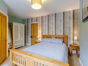 A bedroom with a wooden bed, two bedside tables, a wardrobe, and a door. - 3 Bed in Keswick (oc-86162) (Keswick)