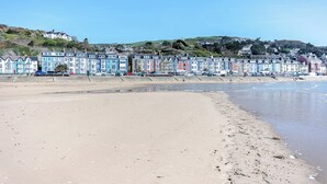 Ein Strand mit bunten Häusern im Hintergrund.