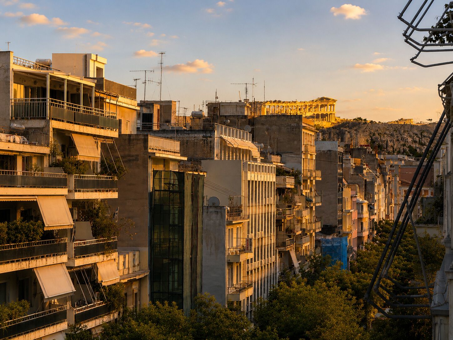 A densely packed urban area with multi-story buildings, some with balconies and terraces.