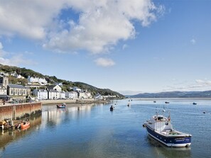 A coastal town with a harbor, boats, and buildings along the shore. - 2 Bed in Aberdyfi (oc-dy017) (Aberdovey)